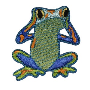May include: Embroidered patch of a green frog with blue and orange accents. The frog is sitting with its legs crossed and has large, black eyes.