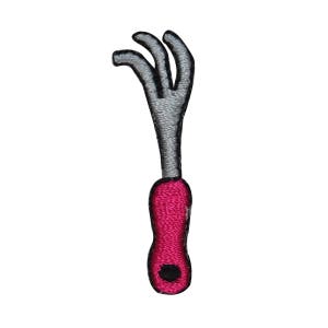 May include: A pink and silver gardening tool with a handle and three tines. The tool is designed to help with weeding and other gardening tasks.