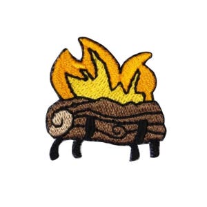 May include: Embroidered patch featuring a campfire design. The patch depicts a brown log with flames in shades of yellow and orange. The flames are stylized, and the log has decorative details. The patch is likely for clothing or accessories.