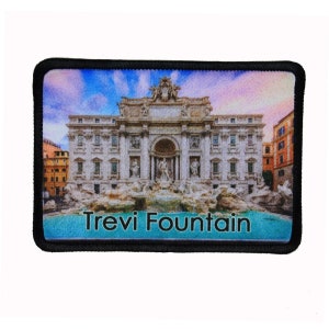 May include: A colorful patch featuring a photo of the Trevi Fountain in Rome, Italy. The fountain is a popular tourist destination and is known for its beautiful architecture and sculptures. The patch is made of fabric and has a black border.