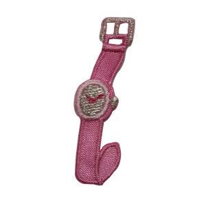 May include: Pink embroidered watch patch with a silver face and pink hands.
