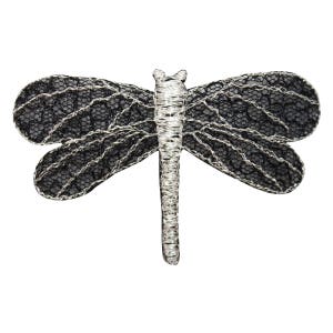 May include: Black and silver lace dragonfly applique. The dragonfly has a delicate, intricate design and is perfect for adding a touch of whimsy to any project.