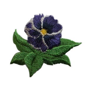 May include: Purple and yellow embroidered flower with green leaves. The flower has a white centre and is surrounded by five petals.