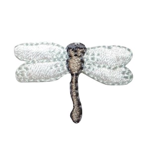 May include: White embroidered dragonfly with a brown body. The dragonfly is a popular motif for crafts and home decor.