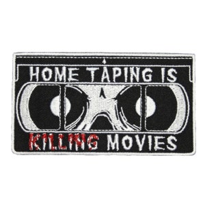 May include: Black and white embroidered patch featuring a cassette tape design. The text "HOME TAPING IS KILLING MOVIES" is embroidered in red on the patch.
