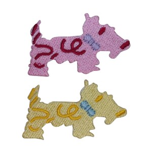 May include: Two embroidered iron-on patches of dogs. One is pink with red stitching and the other is yellow with gold stitching.