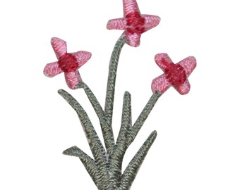 May include: A cluster of three pink flowers with red centers on a green stem. The flowers are embroidered and have a delicate, feminine look.