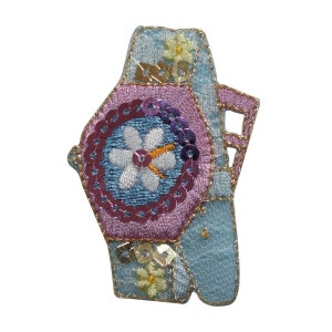 May include: A blue and pink embroidered watch patch with a flower design and sequins. The watch face is a light blue with a white flower and gold accents.