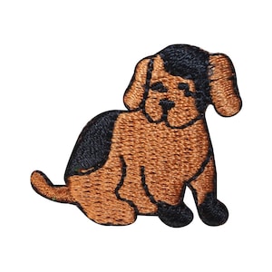 May include: A brown and black embroidered patch of a cartoon dog sitting with its legs crossed.