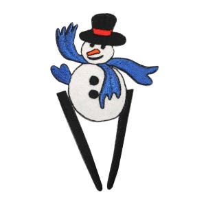 May include: A white snowman with a black top hat, red band, and blue scarf. The snowman is waving with one arm and has two black eyes and a carrot nose. The snowman is on a black stick.