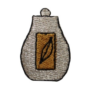 May include: A silver embroidered patch shaped like a bottle with a gold embroidered leaf inside.