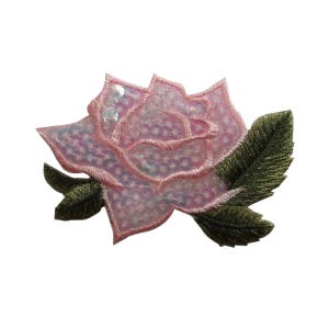 May include: A pink rose with sequins and green leaves. The rose is embroidered and has a shiny finish.