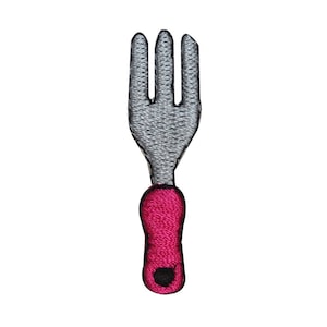 May include: A silver fork with a pink handle. The fork has four tines and a rounded handle.