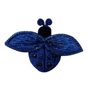 May include: A blue sparkly ladybug with black accents and a glittery finish. The ladybug has a detailed design and is perfect for adding a touch of whimsy to crafts and projects.