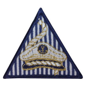 May include: A blue and white striped triangular patch with a gold embroidered captain's hat and rope design.