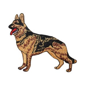May include: Embroidered patch of a German Shepherd dog with brown and black fur. The dog is standing with its head turned to the left and its tongue sticking out.