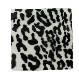 May include: Square piece of fabric with a white background and black leopard print pattern. The fabric has a soft, textured appearance. The leopard spots vary in size and shape, creating a dynamic design.