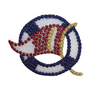 May include: A white, blue, red, and gold embroidered patch in the shape of a stylized letter Q. The patch is made of fabric and has a shiny, beaded texture.