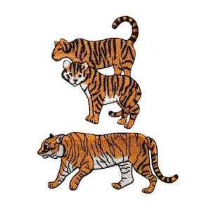 May include: Three embroidered tiger patches. Two tigers are standing on top of each other, and the third tiger is walking. All three tigers are orange and black.