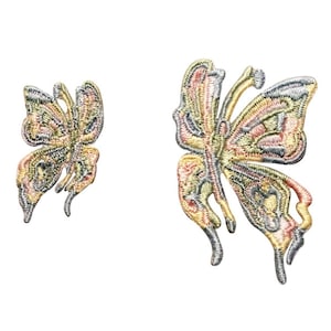 May include: Two embroidered butterfly patches in shades of pink, yellow, and green. The larger butterfly is on the right and the smaller butterfly is on the left.