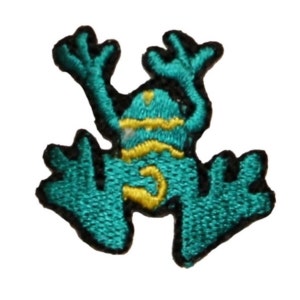 May include: A teal green embroidered frog patch with yellow accents. The frog is in a jumping pose with its arms and legs outstretched.