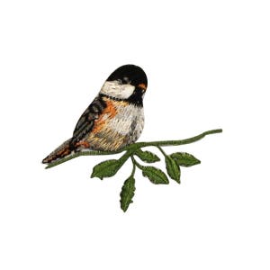 May include: Embroidered iron-on patch of a brown, white, and black bird perched on a green branch with leaves.