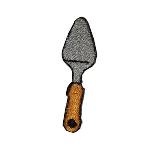 May include: A gray metal spatula with a brown wooden handle. The spatula is a kitchen utensil used for flipping food.