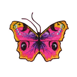 May include: Pink butterfly embroidered patch with yellow and purple accents. The butterfly has a black body and large, round eyes.