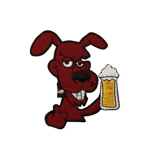 May include: Embroidered patch featuring a cartoon dog with a smug expression, holding a beer mug. The dog is maroon with a black nose and white teeth. The beer mug has yellow liquid and white foam. The patch is on a white background.