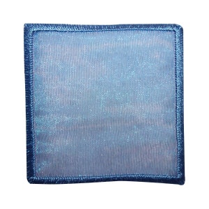 May include: A blue fabric patch with a light blue, shimmery background and a dark blue border.