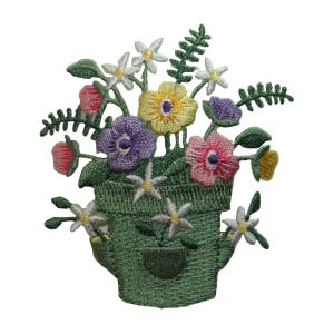May include: Embroidered patch of a green watering can filled with a bouquet of colourful flowers. The flowers include pink, purple, yellow, and white.
