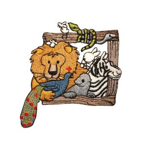 May include: Embroidered patch featuring a lion, zebra, bird, and seal in a wooden frame. The lion is holding a blue bird in its paws. The zebra is standing behind the lion. The bird is facing the lion. The seal is lying on the bottom of the frame. The frame is brown and has a rope design around the top.