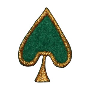May include: A green felt spade with a gold outline. The spade is a playing card symbol.