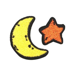 May include: A yellow crescent moon and a red star embroidered patch. The moon has a black outline and the star has a black outline and a white center.