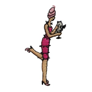 May include: Embroidered iron-on patch of a woman in a pink dress and hat holding a glass of wine.
