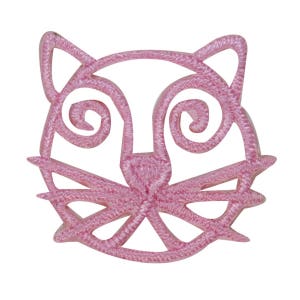 May include: Pink felt applique of a cat face with a simple design. The cat's eyes are swirls and the nose is a simple triangle.