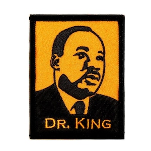 May include: Black and orange embroidered patch featuring a portrait of Dr. Martin Luther King Jr. with the text "DR. KING" below.