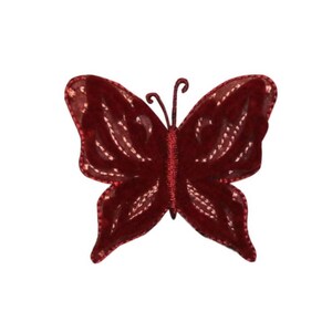 May include: A red velvet butterfly embellishment with a delicate, embroidered design. This decorative butterfly is perfect for adding a touch of whimsy to crafts, clothing, or home decor.