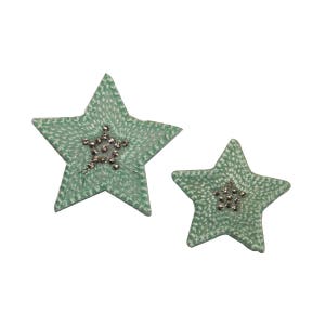 May include: Two green fabric star-shaped ornaments with silver glitter accents.