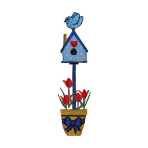 May include: Blue birdhouse with a red heart on the front, perched on a pole with a blue bird on top. The pole is in a yellow pot with a blue bow and red tulips.