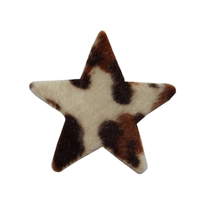 May include: A brown and white cow print star-shaped patch. The patch is made of soft, fuzzy fabric.