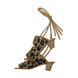 May include: Gold and leopard print fabric applique of a high heeled sandal with a strap and a tassel.