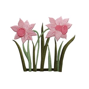 May include: Pink embroidered daffodils with green stems and leaves. The flowers are arranged in a cluster with the stems extending downwards.