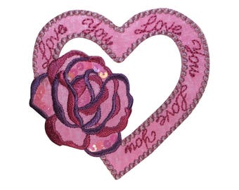 May include: Pink felt heart-shaped patch with embroidered text "Love you more" and a pink rose with purple accents.