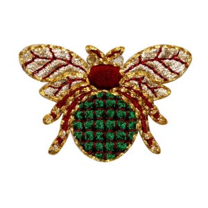 May include: A gold, red, and green embroidered bee patch. The bee has a green and red checkered body and gold wings.