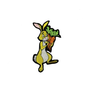 May include: An embroidered iron-on patch featuring a yellow rabbit holding a bunch of carrots. The rabbit has a pink nose and white fur on its belly. The patch is perfect for adding a touch of whimsy to clothing, bags, or other fabric items.