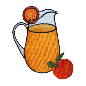 May include: A white pitcher filled with orange juice, with a slice of orange on the rim and a whole orange on the side.