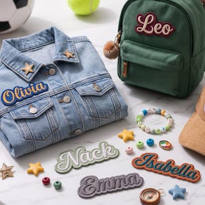 May include: A light blue denim jacket with an Olivia patch, a green backpack with a Leo patch, a tan corduroy baseball cap with a Caleb patch, and name patches reading Nack, Isabella, and Emma, alongside a soccer ball, tennis ball, and baseball glove.