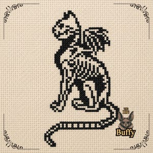 May include: A black cross-stitch pattern on beige fabric depicting a skeletal cat with wings. The design features a feline skeleton in profile with a long tail and feathered wings. In the bottom right corner, there is a small logo with the text THE BIG BUFFY.