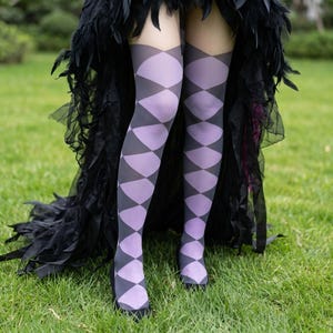 May include: Over-the-knee stockings featuring a repeating harlequin diamond pattern in alternating shades of light purple and dark grey. The hosiery extends from the upper thigh down to the feet, showcasing a geometric design throughout the fabric.